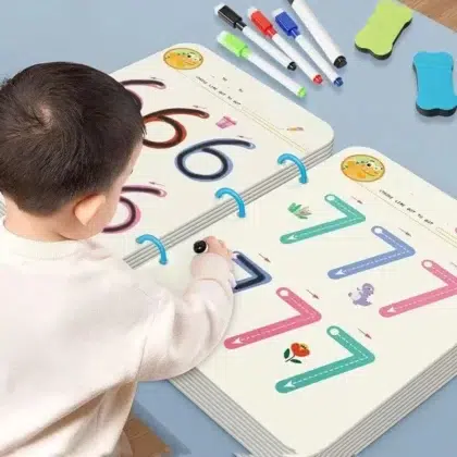 Child practicing numbers with educational book.